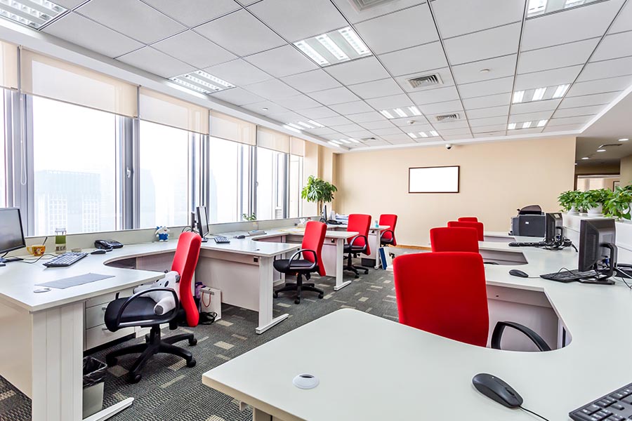 Office Building Insurance - Modern Office with Bright Red Chairs with Big Windows