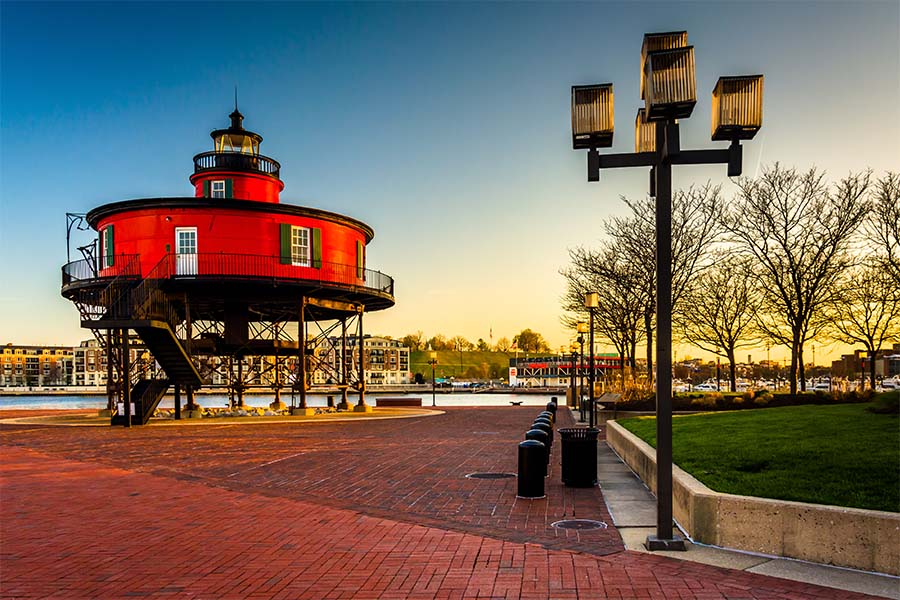 About Our Agency - View of the Seven Foot Knoll Lighthouse at the Inner Harbor of Baltimore Maryland at Sunset