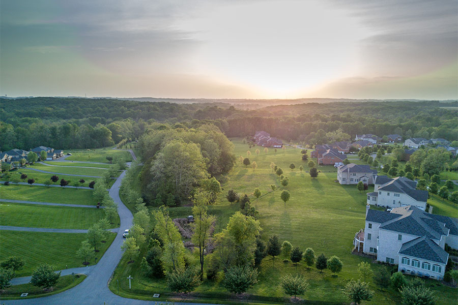 Columbia MD - Scenic View of a Residential Neighborhood Surrounded by Green Trees and Green Grass in Columbia Maryland at Sunset